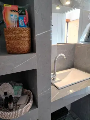 a bathroom with a sink and a mirror at Emily's luxury apartment in Vari