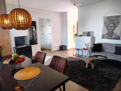 a living room with a table and a couch at Emily's luxury apartment in Vari