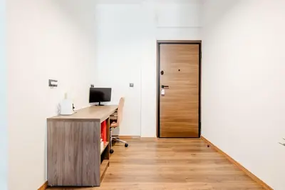 an office with a wooden desk and a door at Ako 25 - stay close to the Acropolis in Athens