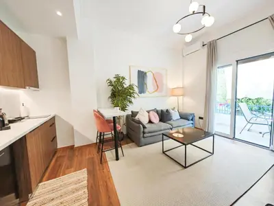 a kitchen and living room with a couch and a table at Sav12 - Cozy home in Athens in Athens