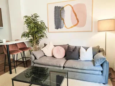 a living room with a couch with pillows on it at Sav12 - Cozy home in Athens in Athens