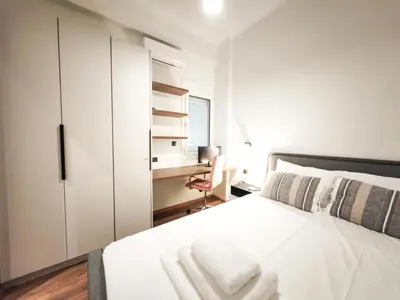 a bedroom with a white bed and a desk at Sav12 - Cozy home in Athens in Athens
