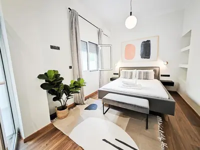 a bedroom with a bed and a potted plant at Sav12 - Cozy home in Athens in Athens