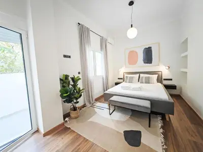 a bedroom with a bed and a large window at Sav12 - Cozy home in Athens in Athens