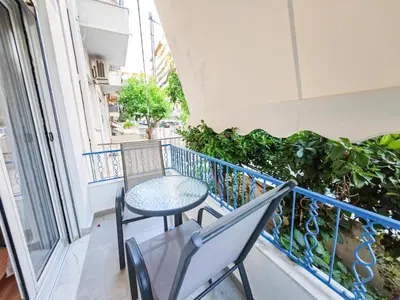 a balcony with a table and chairs and a window at Sav12 - Cozy home in Athens in Athens
