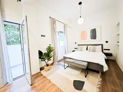 a bedroom with a bed and a large window at Sav12 - Cozy home in Athens in Athens