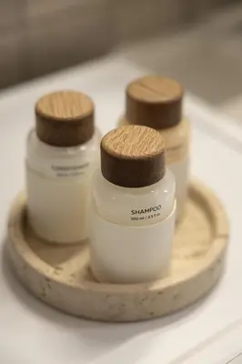 three bottles of shampoos sitting on top of a table at Saronida Hilltop Sea Breeze in Saronida