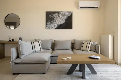 a living room with a couch and a coffee table at Saronida Hilltop Sea Breeze in Saronida