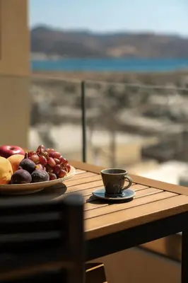 a plate of fruit and a cup of coffee on a table at Saronida Hilltop Sea Breeze in Saronida