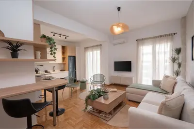 a living room with a couch and a table at LIV - Seaside Getaway in Glyfada in Athens