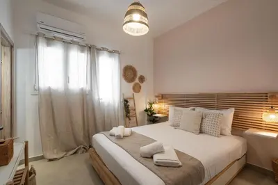 a bedroom with a large bed with towels on it at LIV - Seaside Getaway in Glyfada in Athens