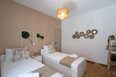 a bedroom with two beds and a ceiling at LIV - Seaside Getaway in Glyfada in Athens