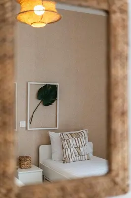 a mirror reflection of a white couch in a room at LIV - Seaside Getaway in Glyfada in Athens