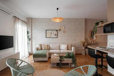 a living room with a couch and a table at LIV - Seaside Getaway in Glyfada in Athens