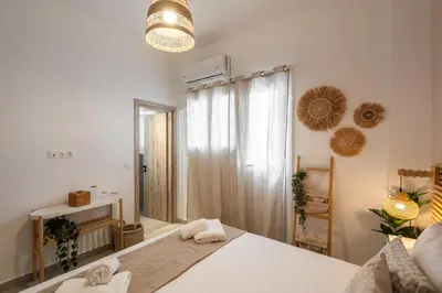 a bedroom with a bed and a large mirror at LIV - Seaside Getaway in Glyfada in Athens