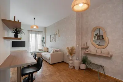 a living room with a couch and a mirror at LIV - Seaside Getaway in Glyfada in Athens