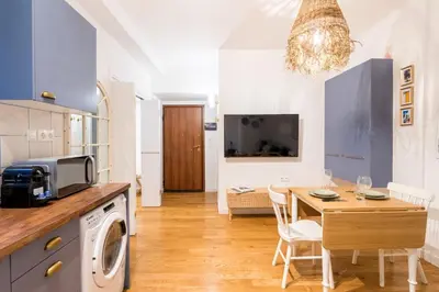 a kitchen and dining room with a table and a microwave at Athenian Thiseos in Athens