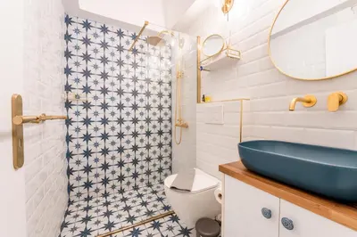 a bathroom with a blue sink and a shower at Athenian Thiseos in Athens