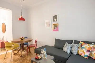 a living room with a couch and a table at Retro Luxury Apartment in Athens