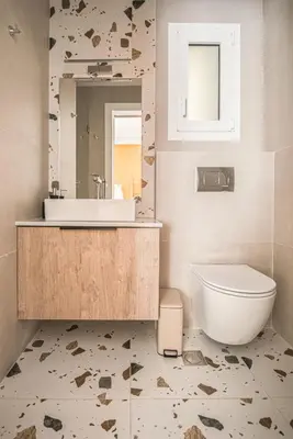 a bathroom with a sink and a toilet and a mirror at Retro Luxury Apartment in Athens