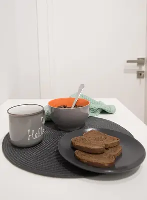 a table with a plate of cookies and a bowl of soup at Retro Luxury Apartment in Athens
