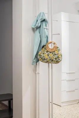 a hat and a bag on a pole next to a closet at Retro Luxury Apartment in Athens