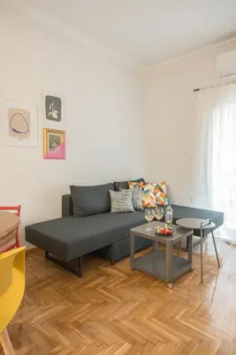 a living room with a couch and a table at Retro Luxury Apartment in Athens