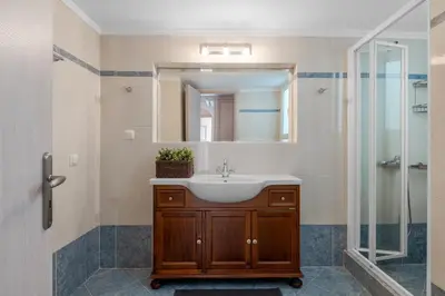 a bathroom with a sink and a mirror at Serenity Apartments in Athens