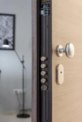 a wooden door with brass knobs on it at Serenity Apartments in Athens