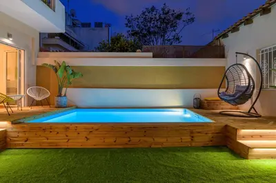 a swimming pool in the middle of a backyard at Serenity Apartments in Athens
