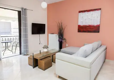 a living room with a white couch and a table at ZenPort in Piraeus
