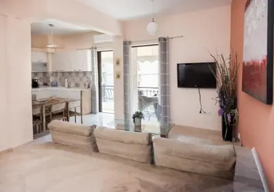 a living room with a couch and a tv at ZenPort in Piraeus