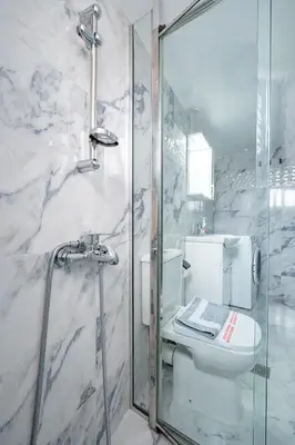 a bathroom with a toilet and a glass shower at Elegant Apartment in Glyfada 2 Bdrms by MPS in Athens