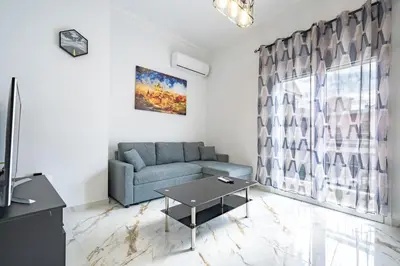 a living room with a couch and a table at Elegant Apartment in Glyfada 2 Bdrms by MPS in Athens