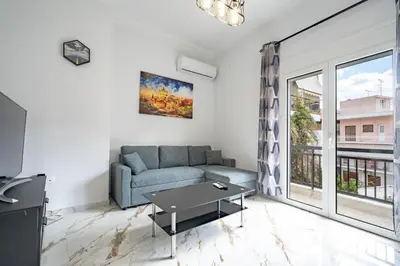 a living room with a couch and a large window at Elegant Apartment in Glyfada 2 Bdrms by MPS in Athens