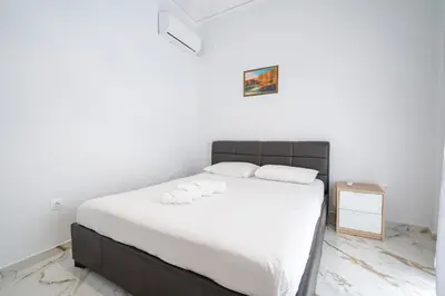 a bedroom with a large bed with white sheets at Elegant Apartment in Glyfada 2 Bdrms by MPS in Athens