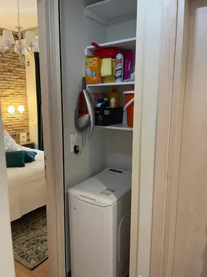 a laundry room with a washing machine in a room at Brick house in Athens