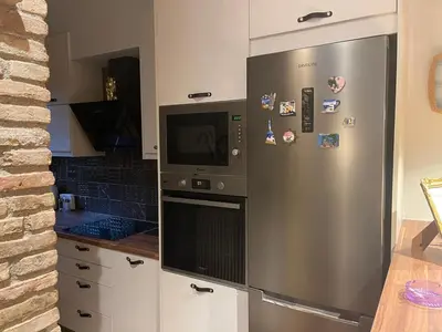 a kitchen with a stainless steel refrigerator and a microwave at Brick house in Athens