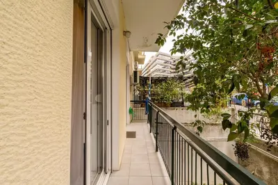 a corridor of a building with a balcony at Little house in the city in Athens