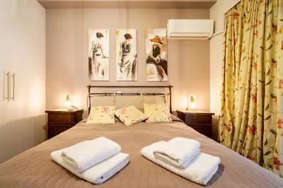 a bedroom with a bed with two towels on it at Little house in the city in Athens