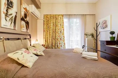 a bedroom with a large bed with two pillows on it at Little house in the city in Athens