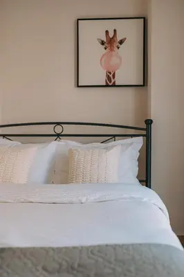 a bedroom with a bed with a deer head on the wall at Modern Apartment Nearby Acropolis & Metro in Athens
