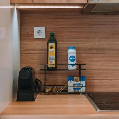 a shelf in a room with a bottle of cleaner at Modern Apartment Nearby Acropolis & Metro in Athens