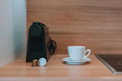 a phone and a coffee cup on a table at Modern Apartment Nearby Acropolis & Metro in Athens