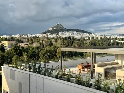 a view from the balcony of a house with a mountain in the background at Acropolis Ray of Light - Spacious Flat - Stunning views in Athens