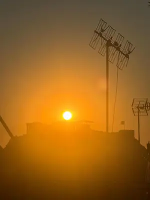 an image of the sun setting in the horizon at Acropolis Ray of Light - Spacious Flat - Stunning views in Athens