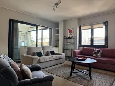 a living room with a couch and a table at Acropolis Ray of Light - Spacious Flat - Stunning views in Athens