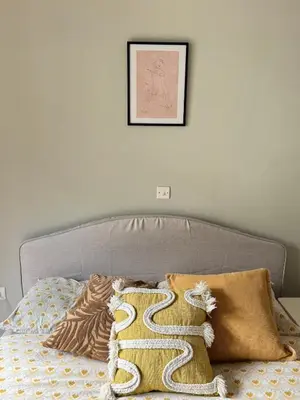 a bedroom with a bed with a picture on the wall at Acropolis Ray of Light - Spacious Flat - Stunning views in Athens