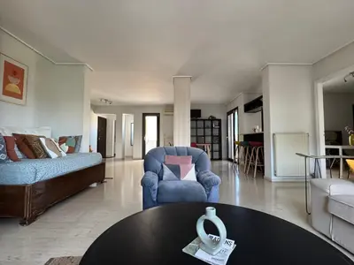 a living room with a couch and a table at Acropolis Ray of Light - Spacious Flat - Stunning views in Athens