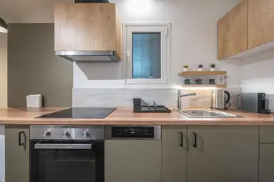 a kitchen with a sink and a counter top at Airy 1BR by Flisvos Marina in Athens